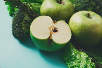Flat lay of green vegetables on bright background