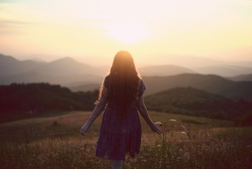 Young woman walking in a field