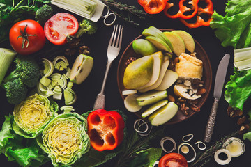 Eating healthy vegetable food on black background.