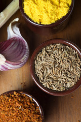 Spices and herbs in ceramic bowls. Food and cuisine ingredients. Colorful natural additives.