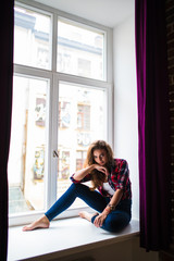 Fototapeta premium Young beauty Woman relax on windowsill background