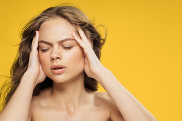 Fototapeta premium Beautiful young woman on a yellow background