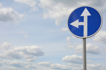 Road sign to the left and directly opposite the blue sky. Way signal with blue sky.