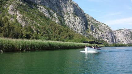 Fototapeta na wymiar Omis, Croatia - June 23, 2017: Boat cruise on the canyon of the river Cetina