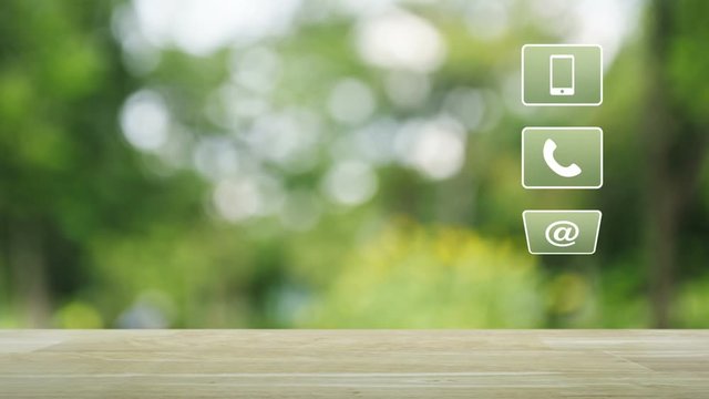 Telephone, mobile phone, at and email buttons on wooden table over blur green tree background, Customer support concept