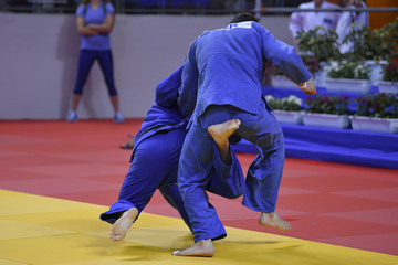 Male Judoka fighters during Judo competition 