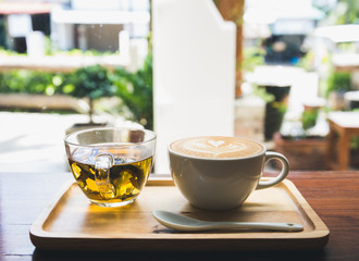Cup of coffee on wooden table with cup of tea