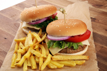 fresh tasty burger and french fries on wooden table