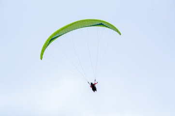 Colorful hang glider/paraglider against the blue sky
