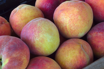 many organic peaches fruit basket at the market