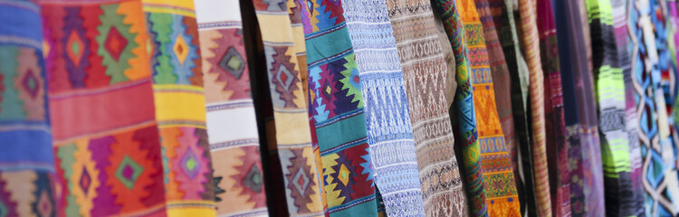 An Assortment of Colorful Blankets Hanging in a Row - 165320977