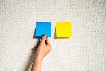 付箋を手に取る女性