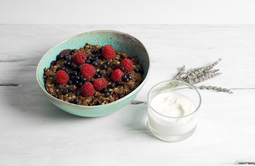 Healthy oat and almond flour berry crumble with soja yogurt
