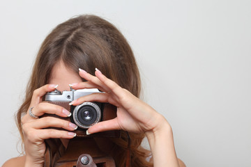 photographer holding a film camera in hands