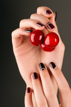 fashion manicure female hand with cherry