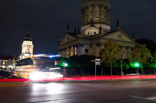 Distant tourist bus is moving slowly around Berlin at night