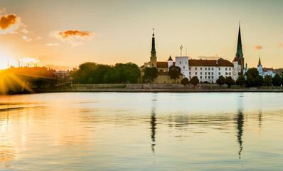 Fototapeta na wymiar View on old palace building and medieval churches in Riga city from left bank of the Daugava river