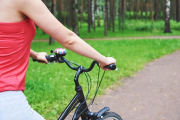 Young girl riding a bike in a park.
