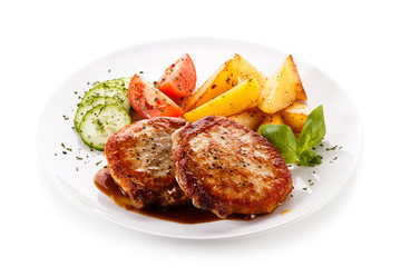 Grilled steaks, chips and vegetable salad