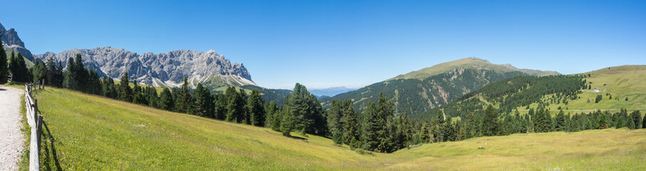 Views of the mountains and the meadows of the Dolomites. The place is around the Pass of Herbs