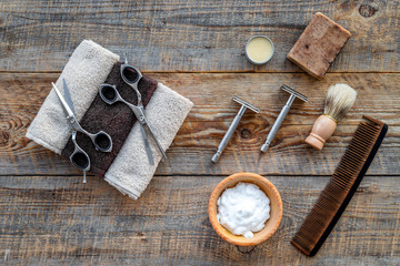 Barbershop. Men's shaving and haircut. Brush, razor, foam, sciccors on wooden table background top view