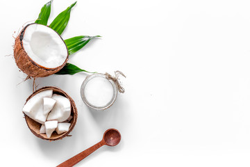 Body treatment. Coconut oil on white background top view copyspace