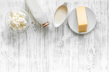 Farm products. Milk, cottage, cheese on light wooden background top view copyspace