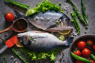 Top view of tasty dorado fish with vegetables and spices
