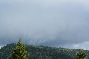 Dark clouds peeking over the top of the mountain.