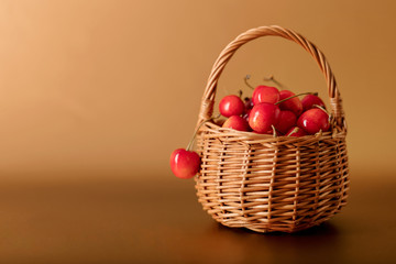 Cherries in a basket on a gold background.
