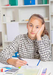 Teenage girl preparing for exams. Teenage girl doing homework for school.