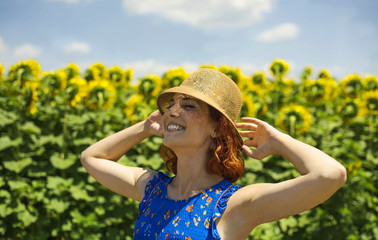 redhead girl enjoy in sun on country field