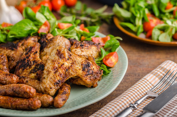 Grilled chicken wings and sausages