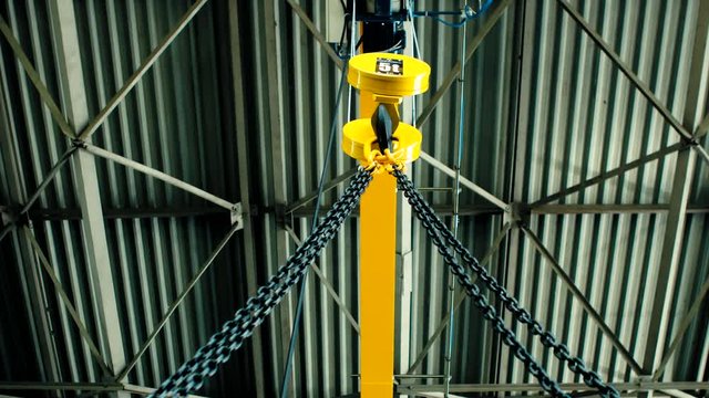 Overhead crane moves in large workshop