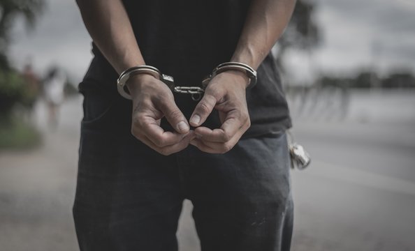 Vintage tone,man in handcuff on highway background concept crime hijacking on railway/highway