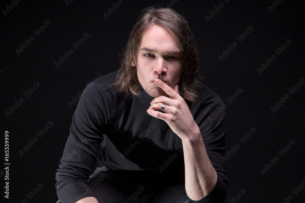 Wall mural portrait of puzzled brunette young man