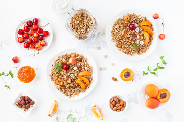 Breakfast with muesli, fruits, berries, nuts on white background. Healthy food concept. Flat lay, top view