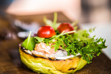 Sandwich hamburger with and mix of vegetables.