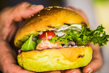Sandwich hamburger with and mix of vegetables.