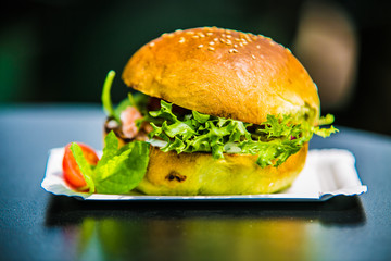 Sandwich hamburger with and mix of vegetables.
