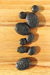 A spa background image consisting of lava beads on a wood. 