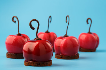 Glossy mousse cakes in the form of cherries