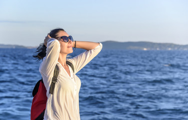 Young woman on the beach at sunset.