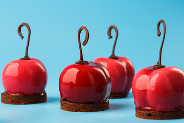 Glossy mousse cakes in the form of cherries