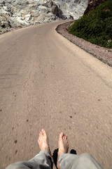 Human feet above the road, Hormuz Island, Hormozgan Province, Iran.