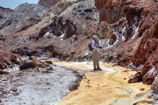 Tourist strolls through natural sights of southern Iran, Hormuz Island.