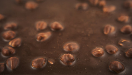 Chocolate background. Milk chocolate with hazelnuts close-up.