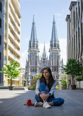 The girl is sitting on the street