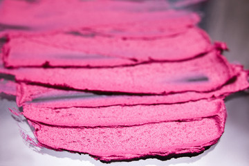 Many pink lipstick strokes in selective focus. Beautiful style background, cosmetics commercial, creative advertising, bright colors. Glamorous magazine, beauty concept