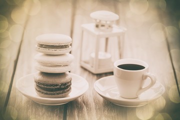 Cup of coffee and macarons with decorate lamp